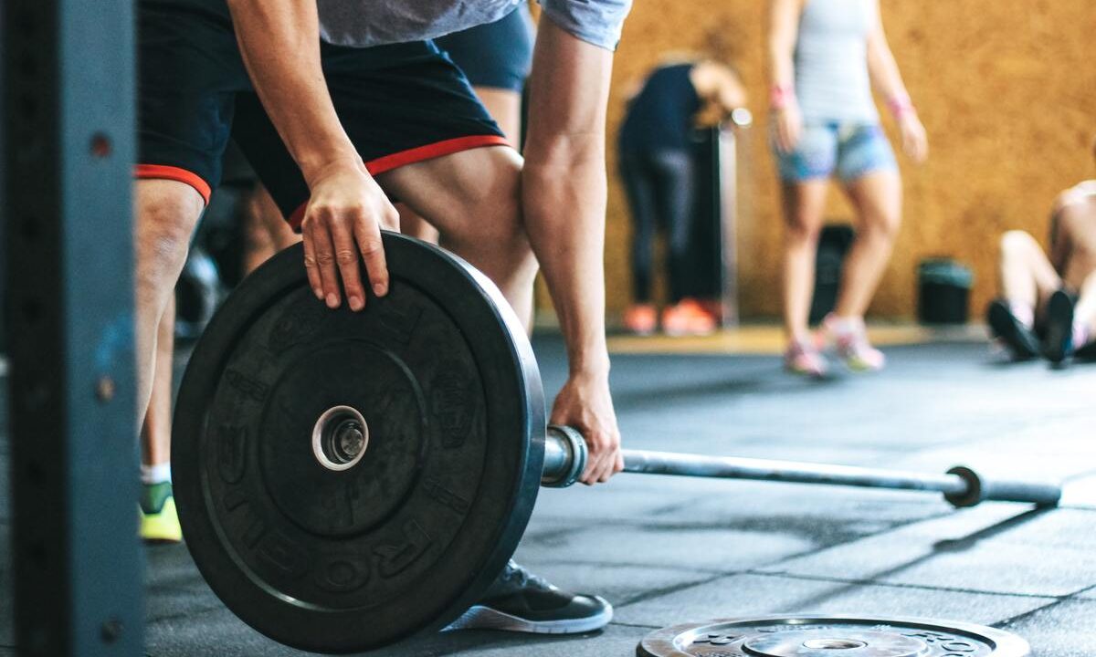 Man loading barbell.