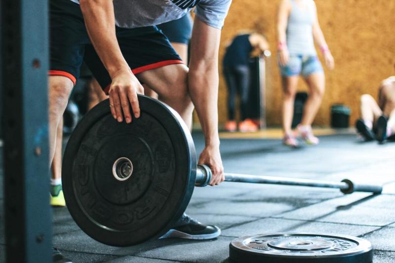 Man loading barbell.