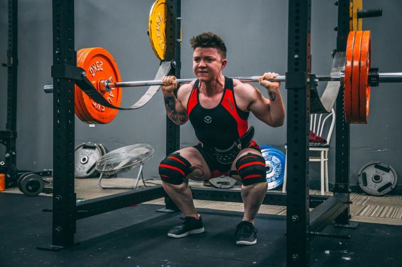 Man doing barbell back squat
