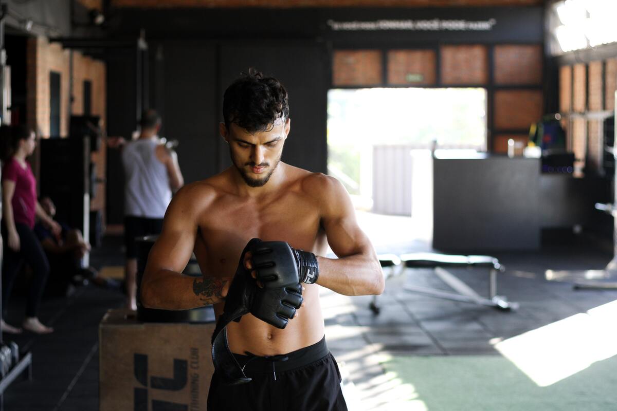 Man putting on boxing gloves