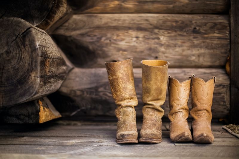 Cowboy boots on a wooden porch.