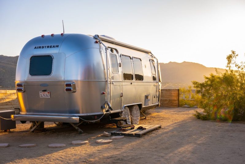 A silver airstream parked at Joshua Tree.