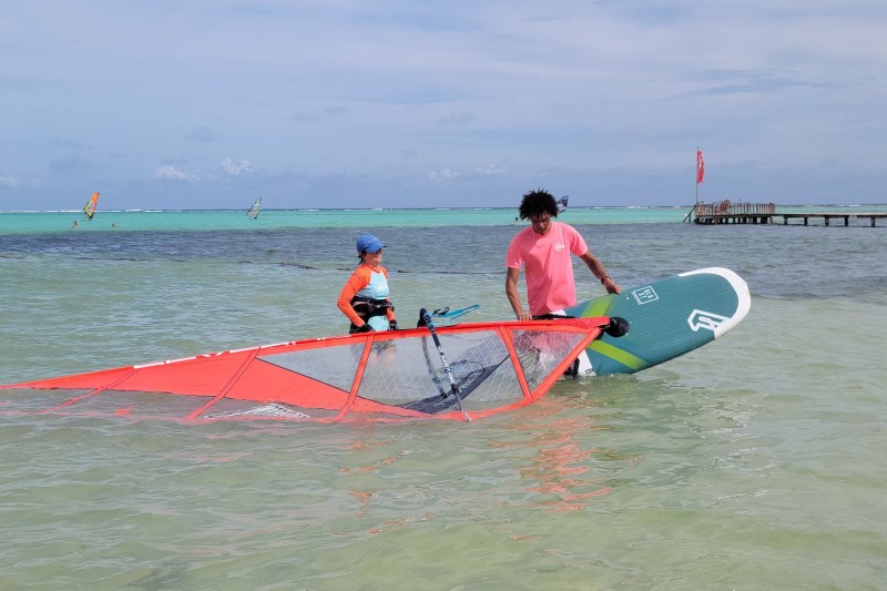 A pair of windsurfers are in the water at Sorobon Beach in Bonaire.
