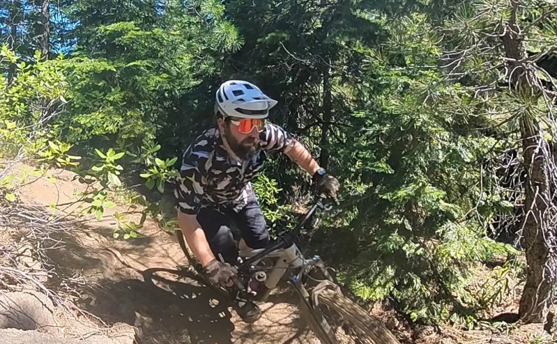 Going around a corner on a mountain bike with the Smith Forefront 2 helmet and Smith Wildcat sunglasses
