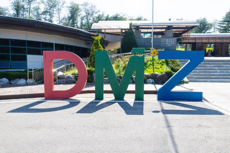 Colourful sign for the Demilitarised Zone with shadows, on the North-South border in Korea at the third tunnel sight