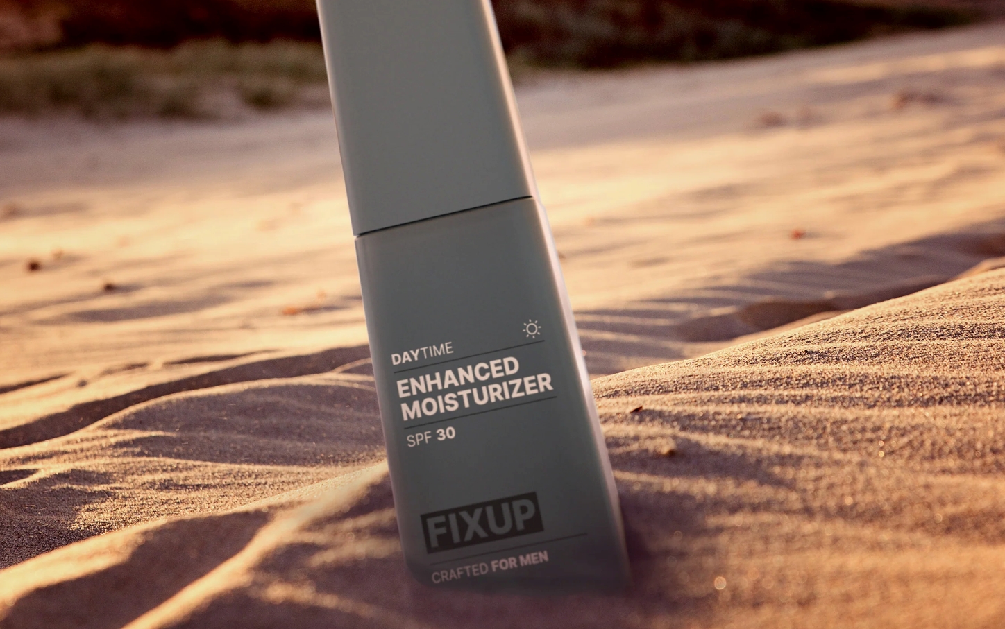 FixUp moisturizer bottle in sand