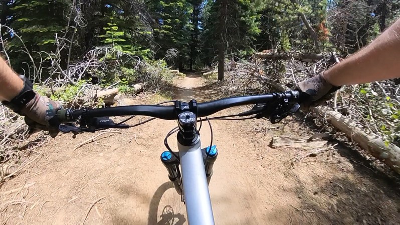 Riding a mountain bike trail using the Insta360 X3