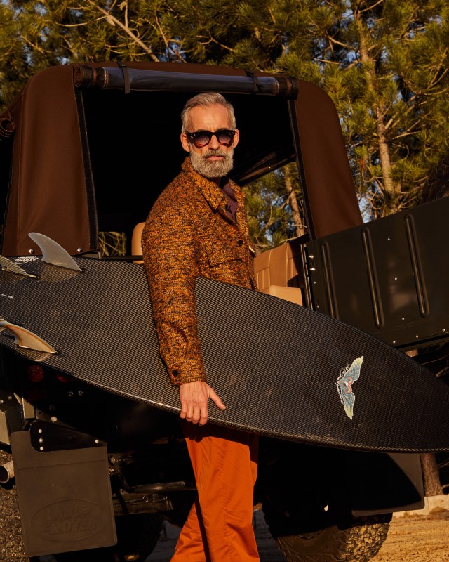 Man in bright clothing and surfboard