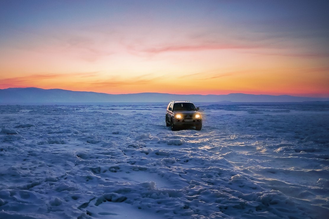 An SUV parked in a snowy remote location
