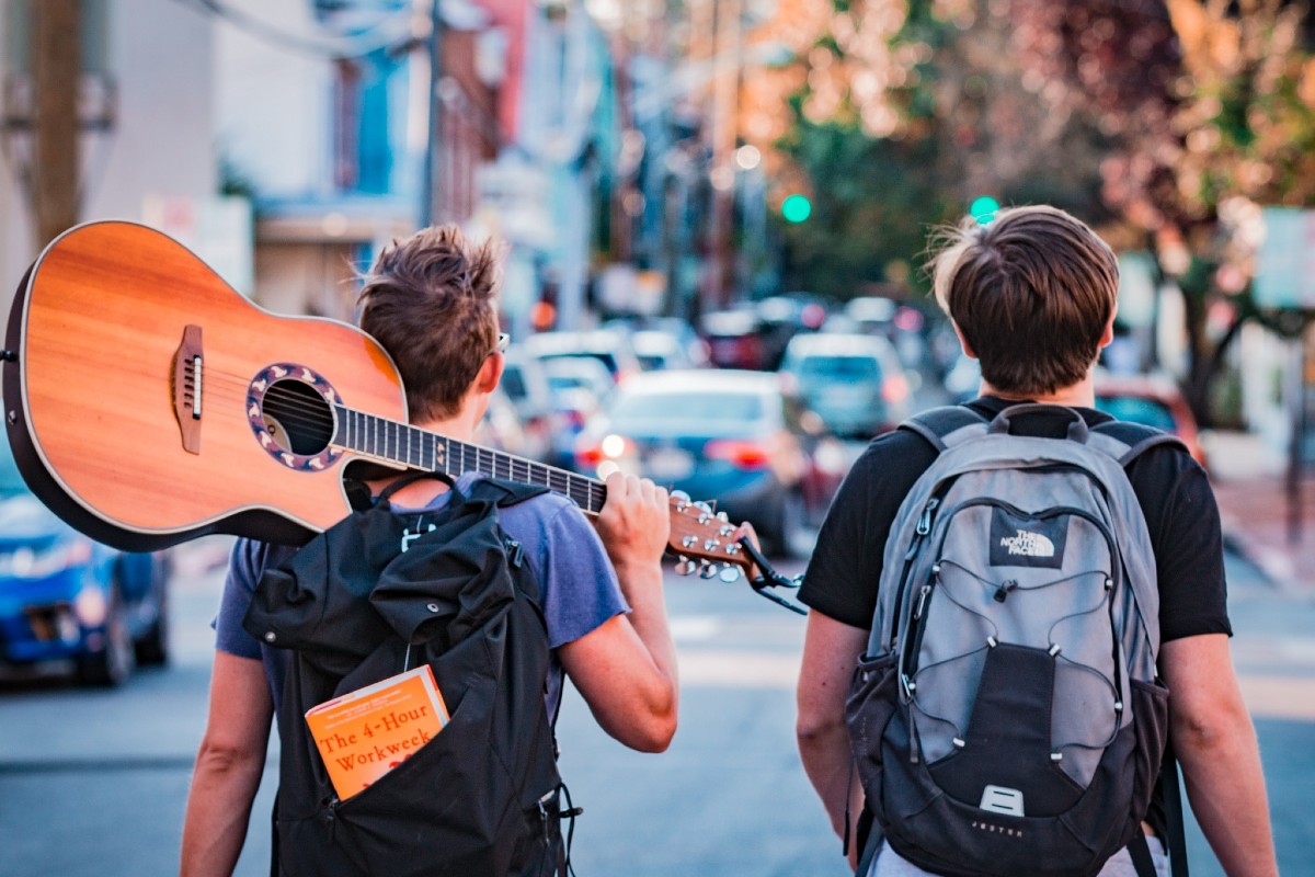 Two people wearing regular backpacks in the city