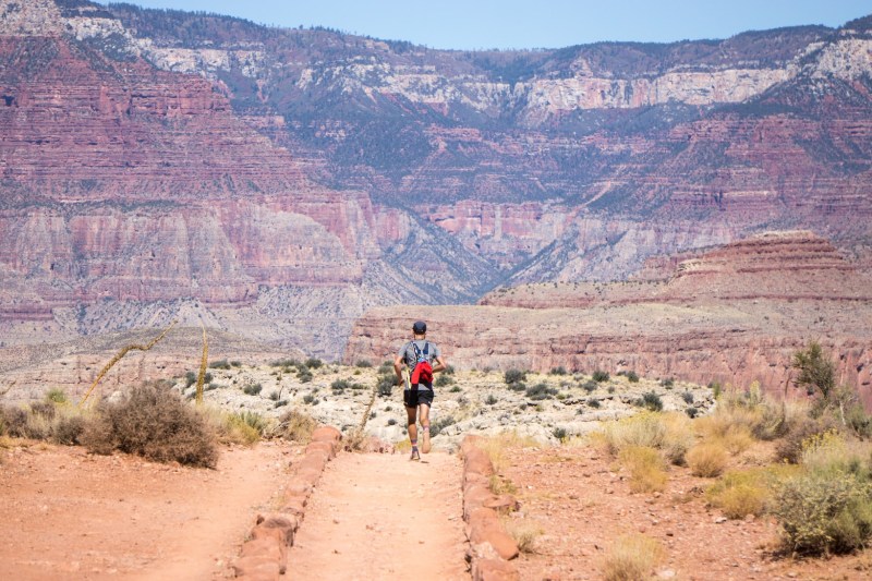Man running through the desert landscape of The Grand Canyon.