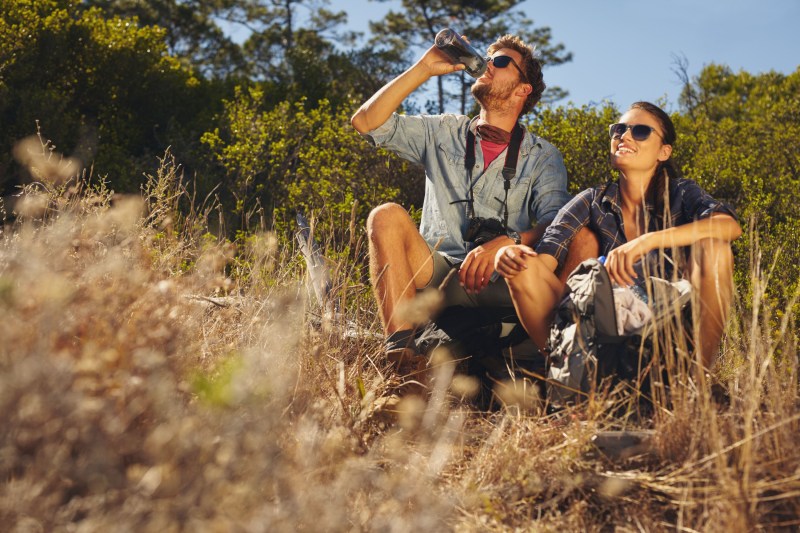 Couple hiking and drinking water