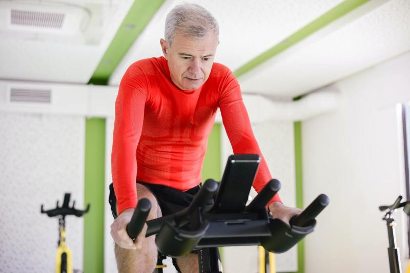 Older man on stationary bike.