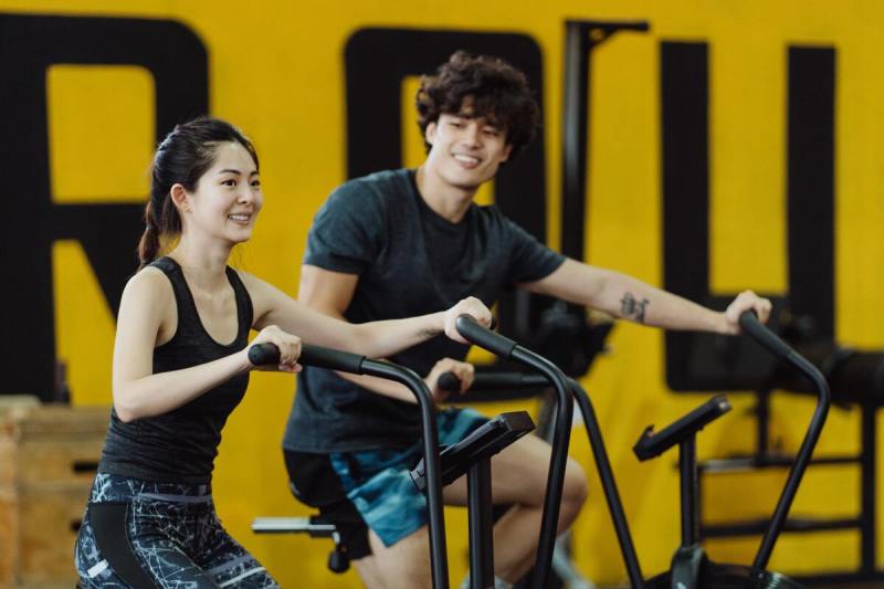 Man and woman on stationary bikes.