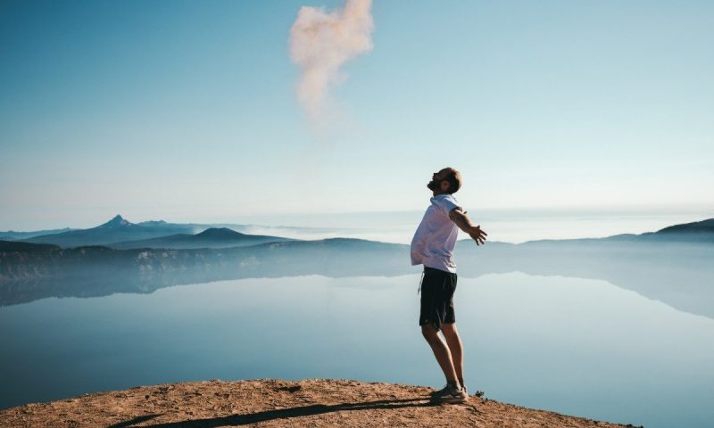 A happy man under a blue sky