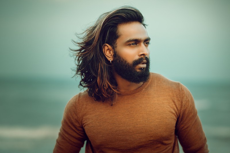 Man with long hair on a beach