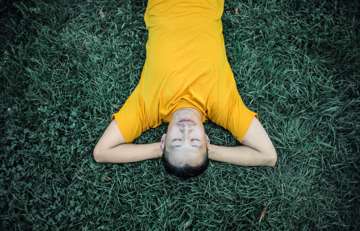 a man napping in the grass