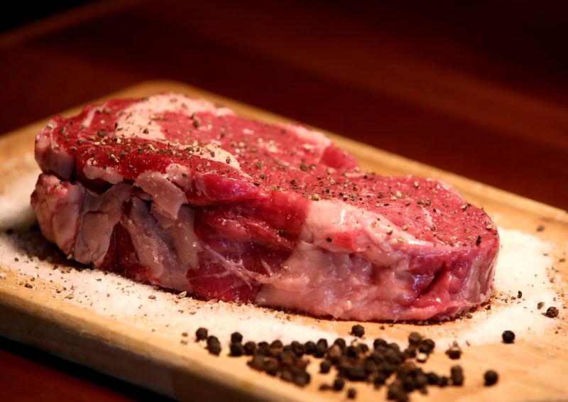 Raw steak on cutting board