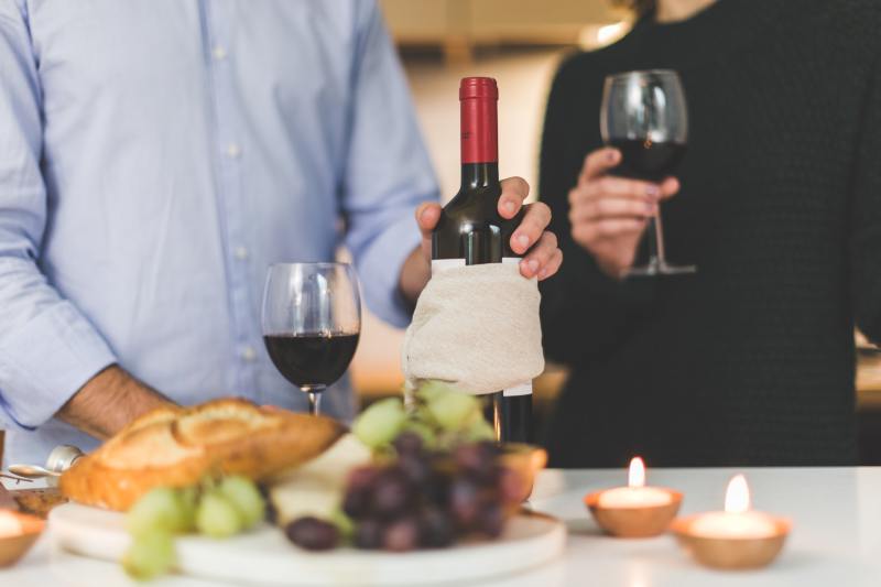 Person holding wine bottle