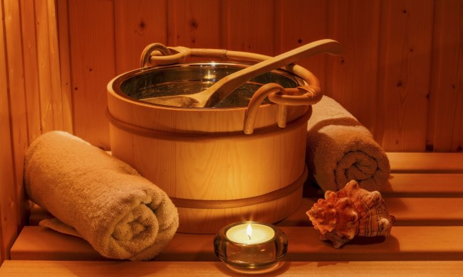 Sauna accessories in the glow of a tea light.