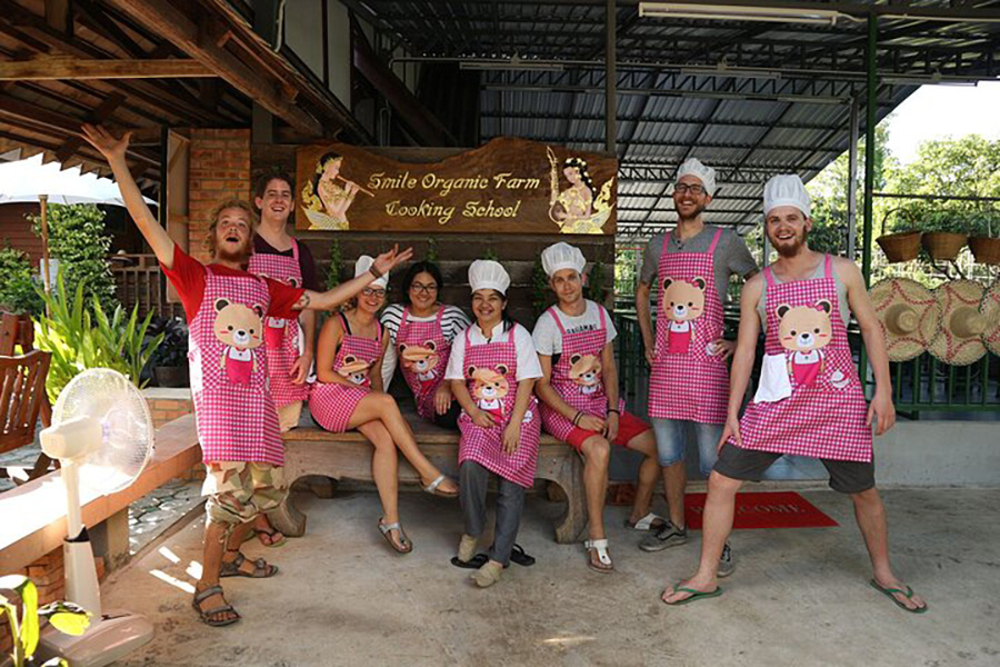 A group of people taking an authentic Thai cooking course on a TripAdvisor tour.