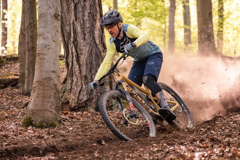 A mountain biker rides through the woods