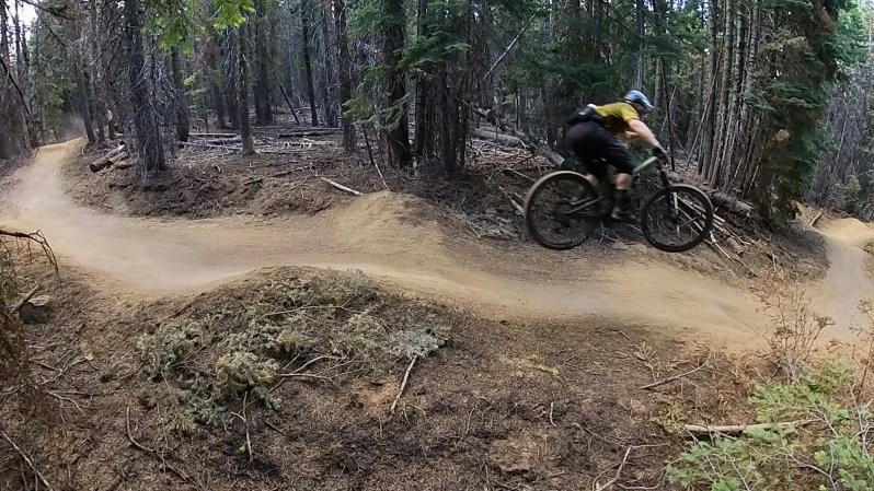 Jumping a gap on a mountain biking trail