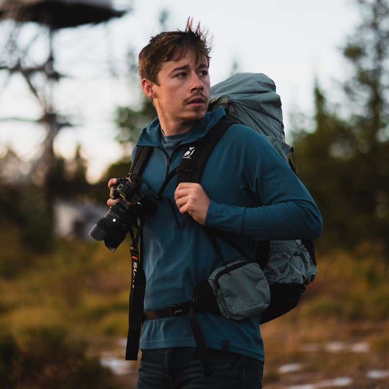 Man wearing an Outdoor Vitals hoodie and a backpack while hiking