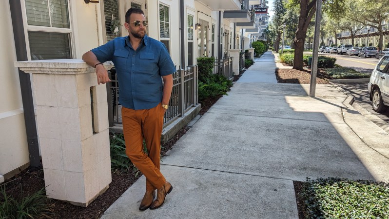 Man in blue shirt and orange pants