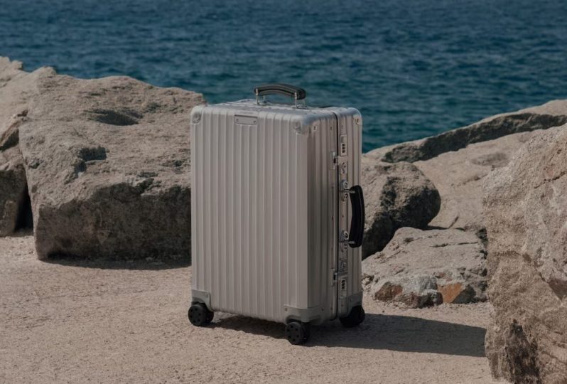 Rimowa suitcase by the beach.