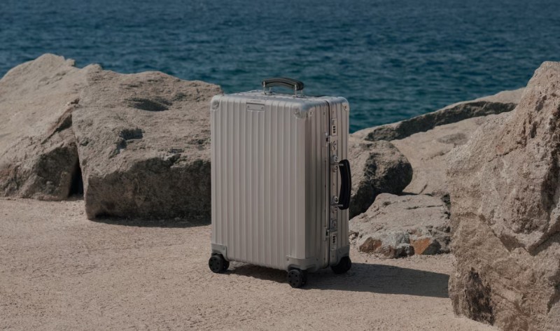 Rimowa suitcase by the beach.