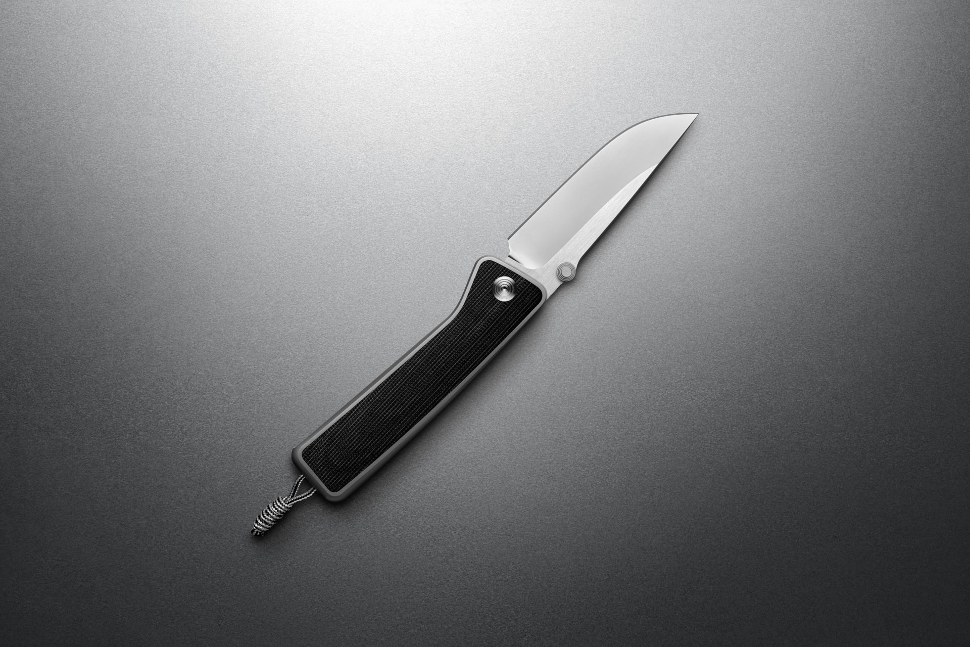 The James Barnes Micarta knife, open on a grey background.