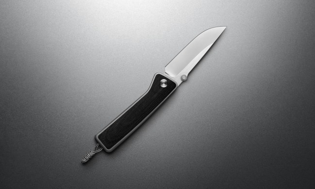 The James Barnes Micarta knife, open on a grey background.