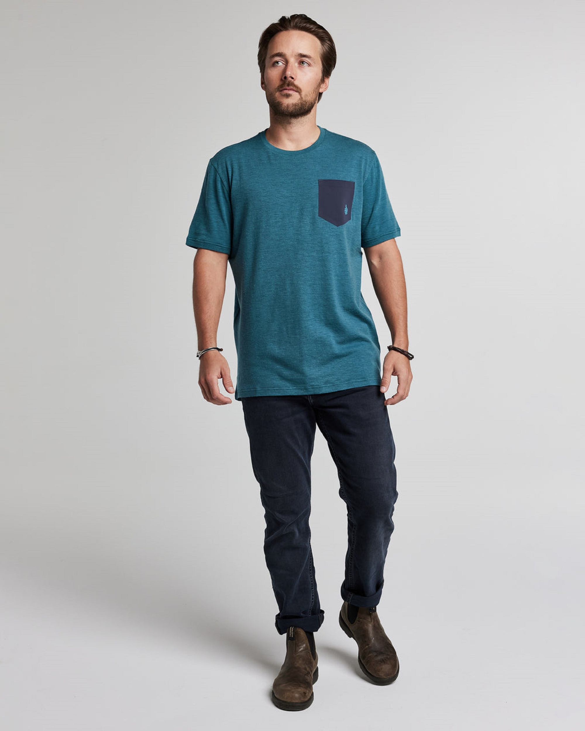 Man wearing a blue TREW t-shirt and jeans
