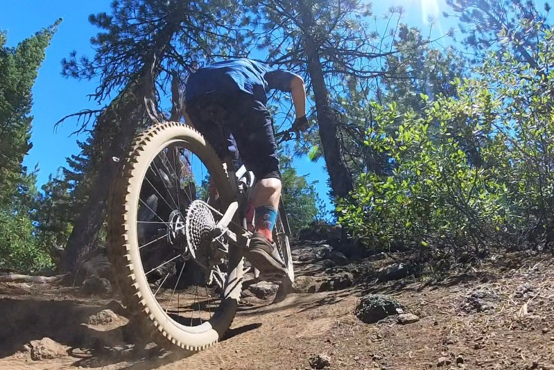 Pedaling a mountain bike up a hill is harder than going down. Riders coming down should stop.