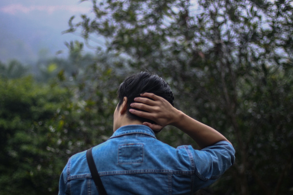 a man in a chambray shirt holding neck