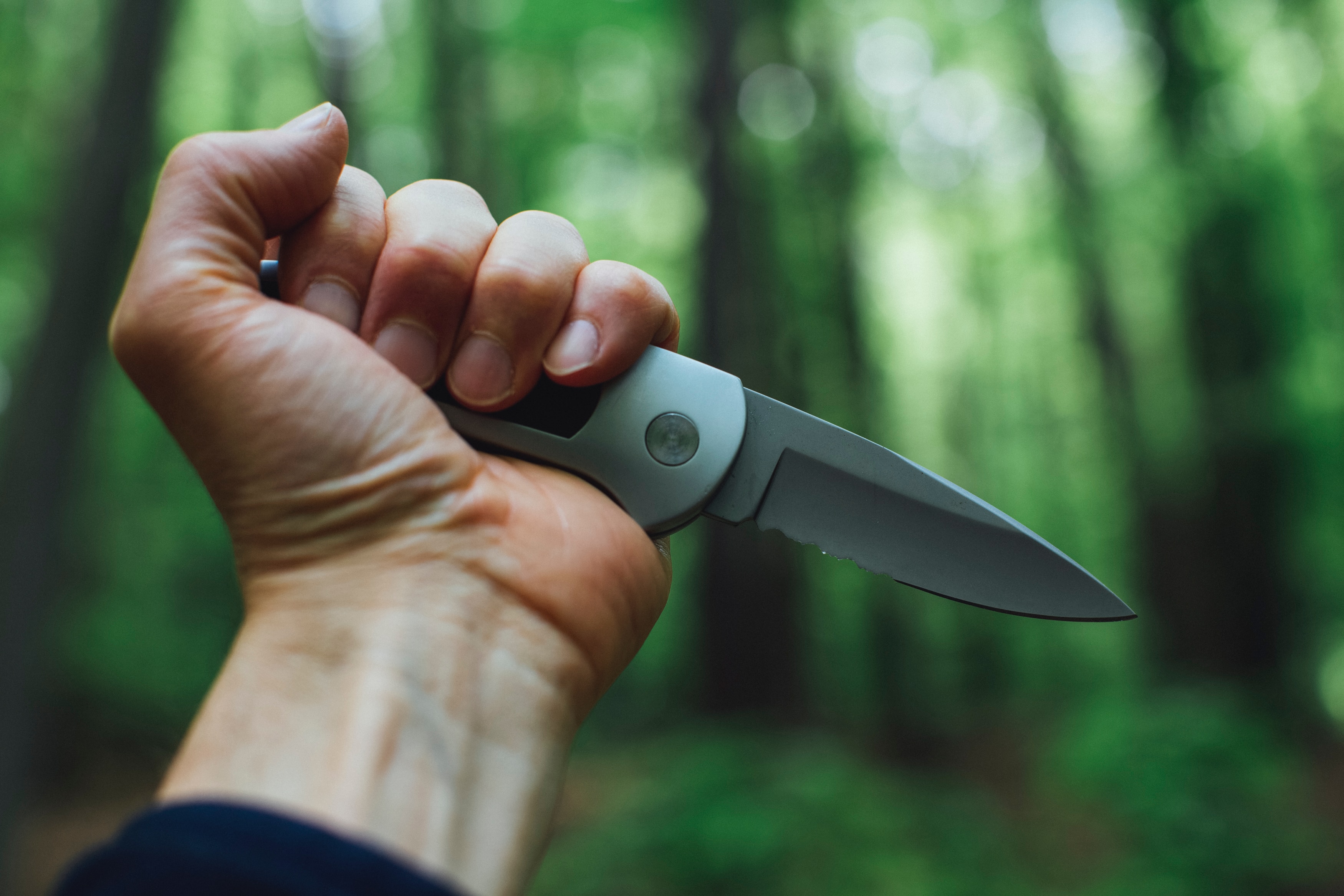 Man holding knife in woods
