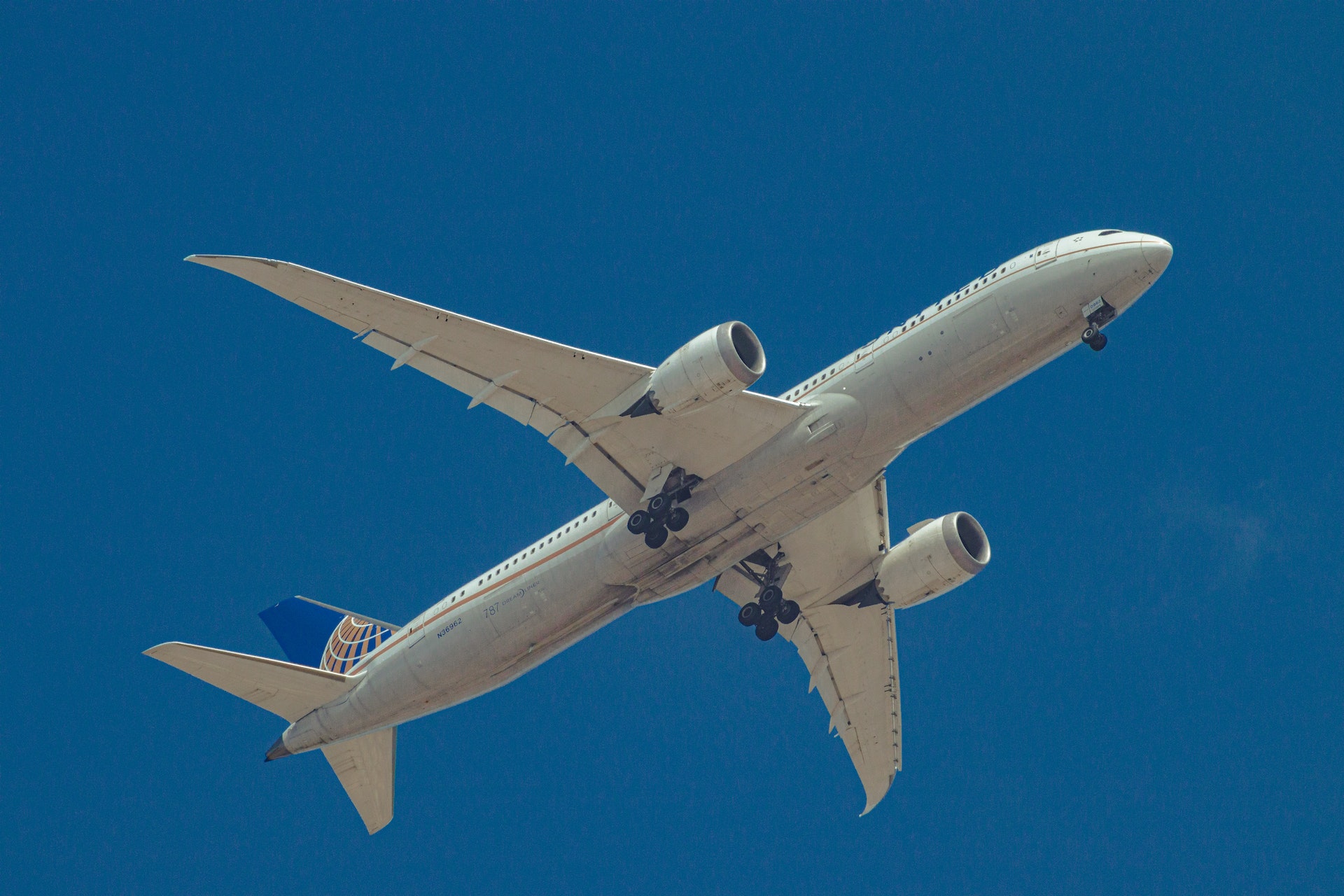 An airplane flying through clear blue sky