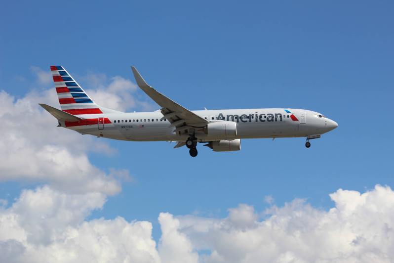 An American Airlines plane in flight in a cloudy sky