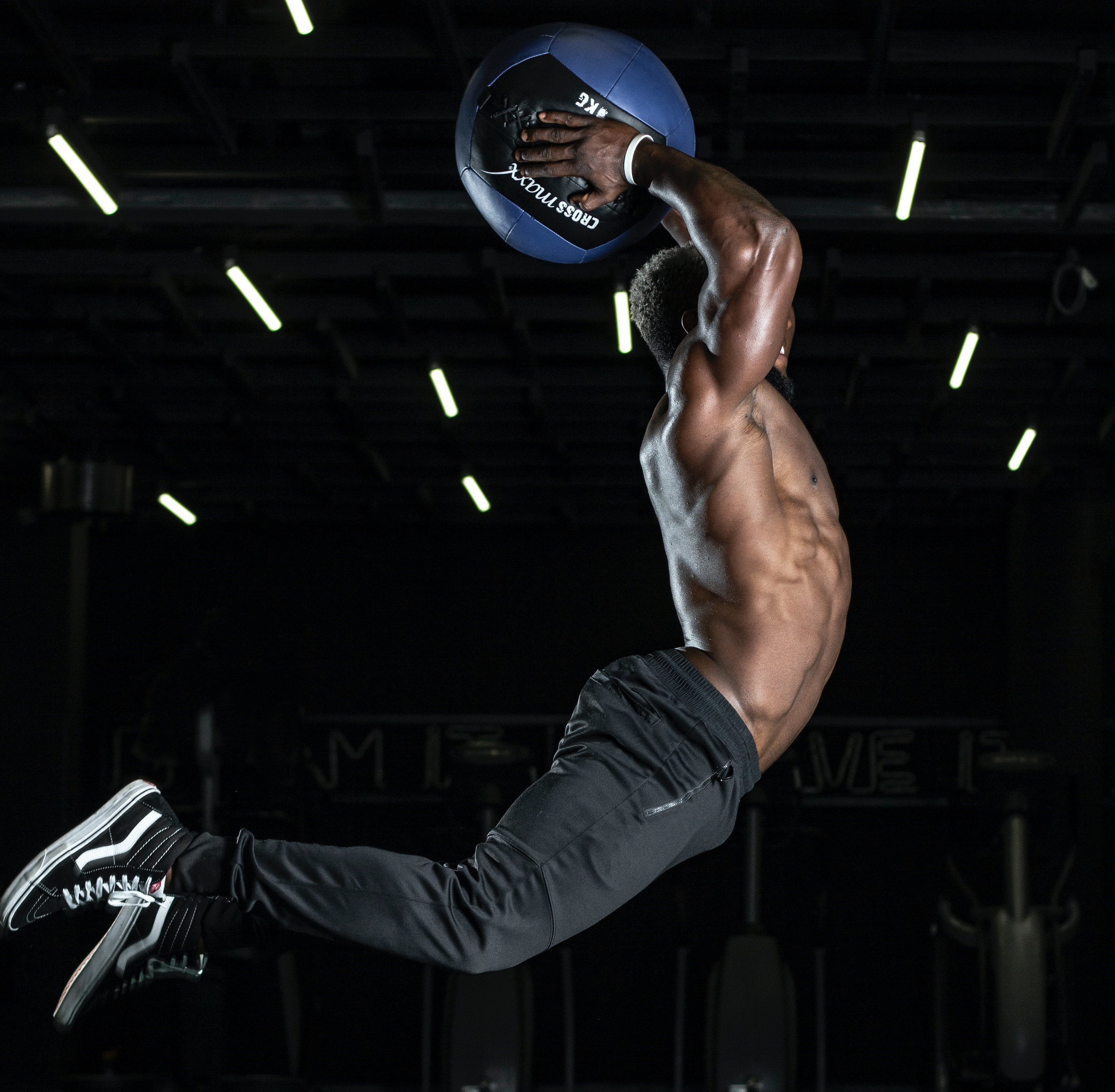 Man with exercise ball jumping in the air