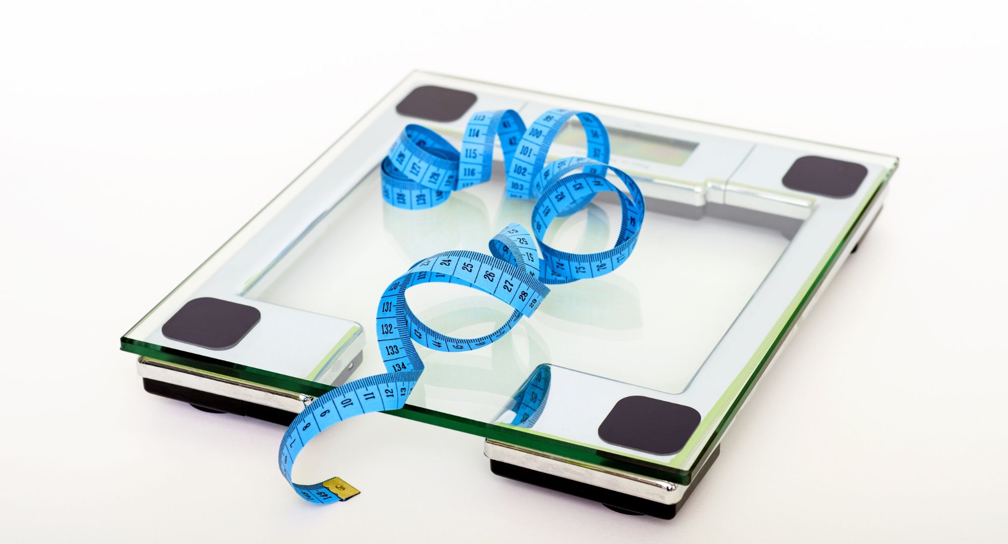 Clear glass scale with blue measuring tape 