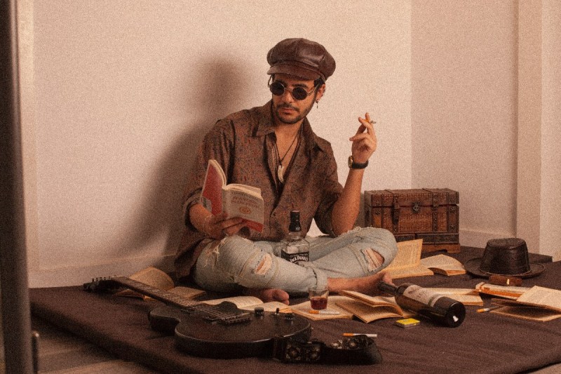 A stoned guy reading a book.