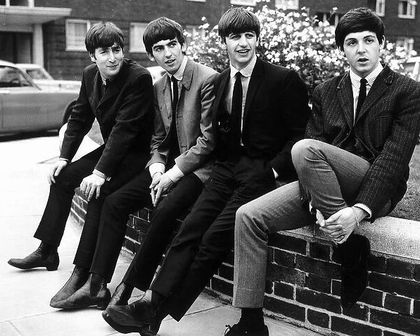 Beatles sitting on a wall