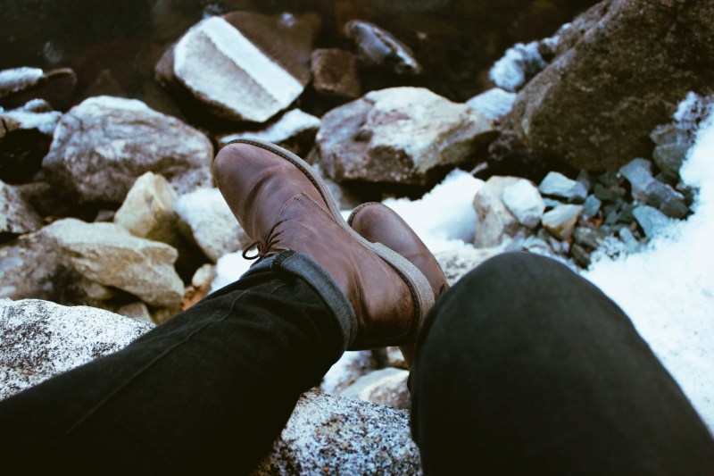 Brown chukka boots on rocks