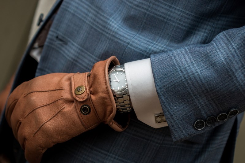 Man in suit, cufflinks, watch, and gloves
