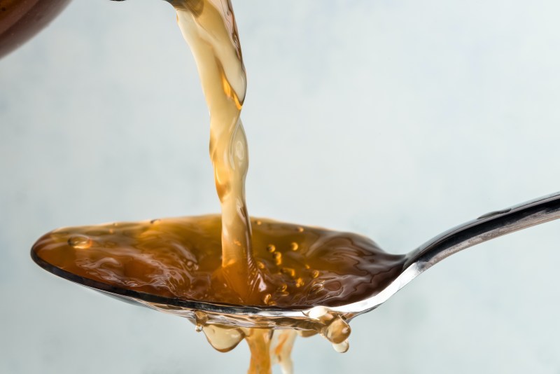 Pouring apple cider vinegar on a spoon