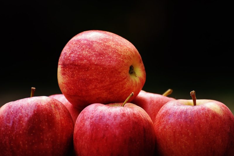 Apple pile with a black background