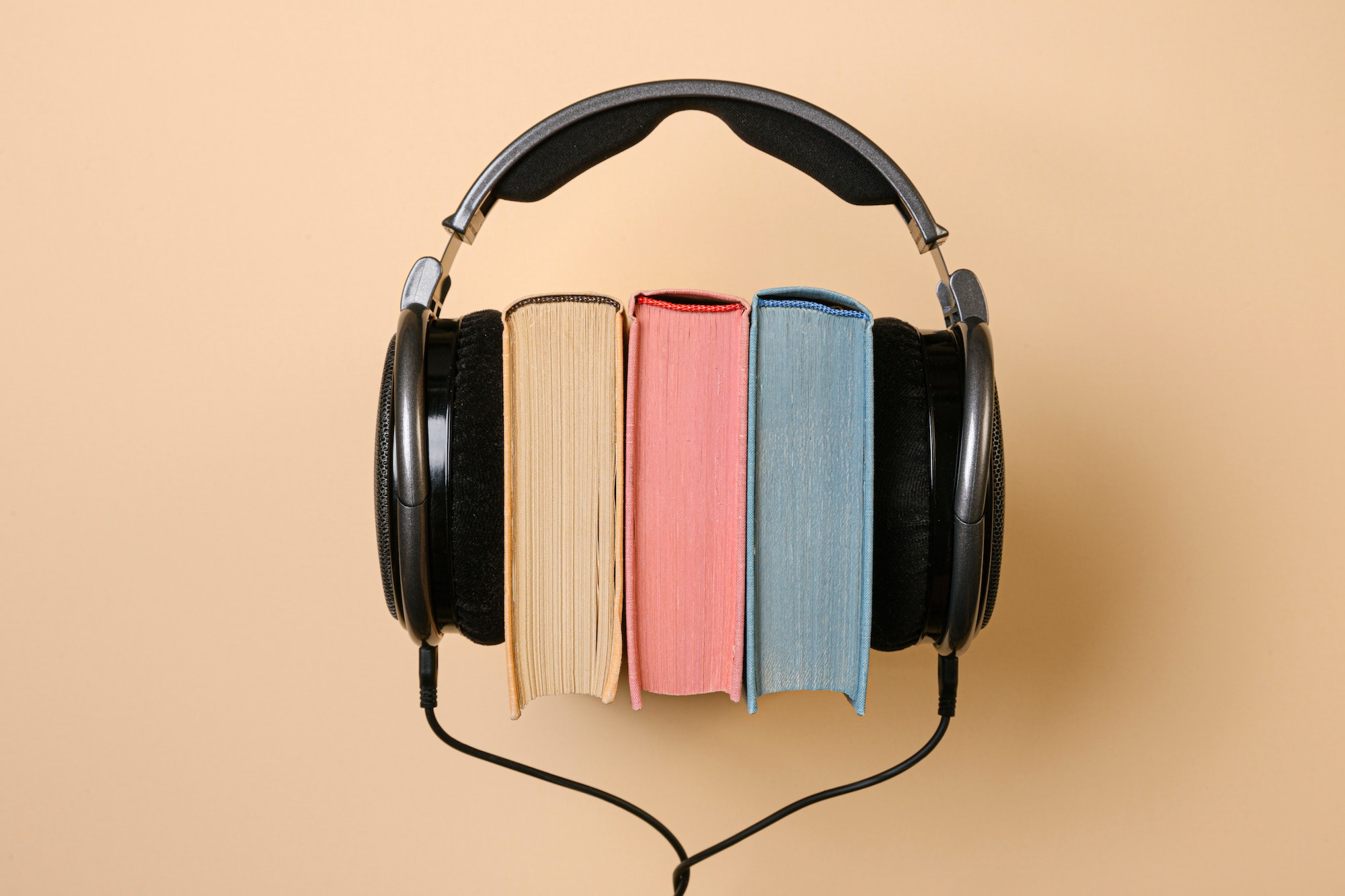 A stack of books with headphones on either side