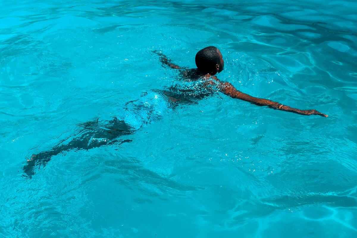 Man swimming in pool.