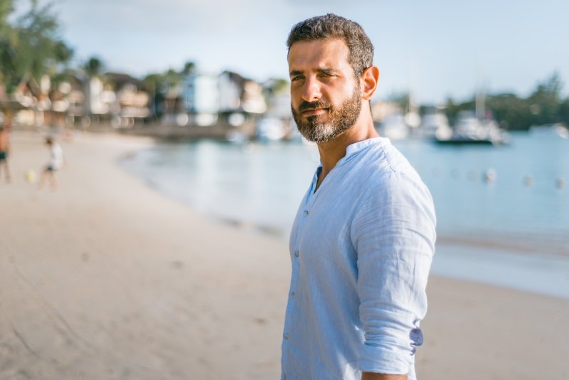 A graying man on a beach